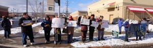 Citizens concerned with the downward spiral taken by global corporations to dismantle our economy stand in front of the Ithaca Wal-Mart on Black Friday to bring attention to Wal-Mart's egregious actions. (Photo: Paul Gottleib)