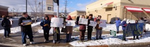 Citizens concerned with the downward spiral taken by global corporations to dismantle our economy stand in front of the Ithaca Wal-Mart on Black Friday to bring attention to Wal-Marts egregious actions. (Photo: Paul Gottleib)