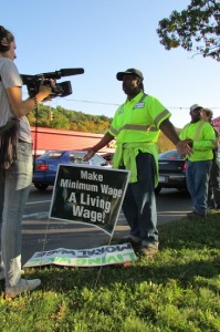 Milton Webb in foreground and Stanley McPherson in the background, along with the Tompkins County Workers Center, outside ReCommunity Recyling in mid-October 2013 advocating for a Living Wage for all County-contracted workers, in general, and workers at the Countys recycling facility, in particular.